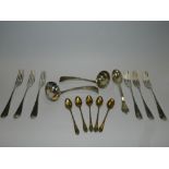 A pair of Old English pattern silver sauce ladles together with a set of six silver dessert forks,