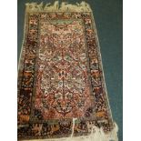 A modern tree of life design red and cream ground rug