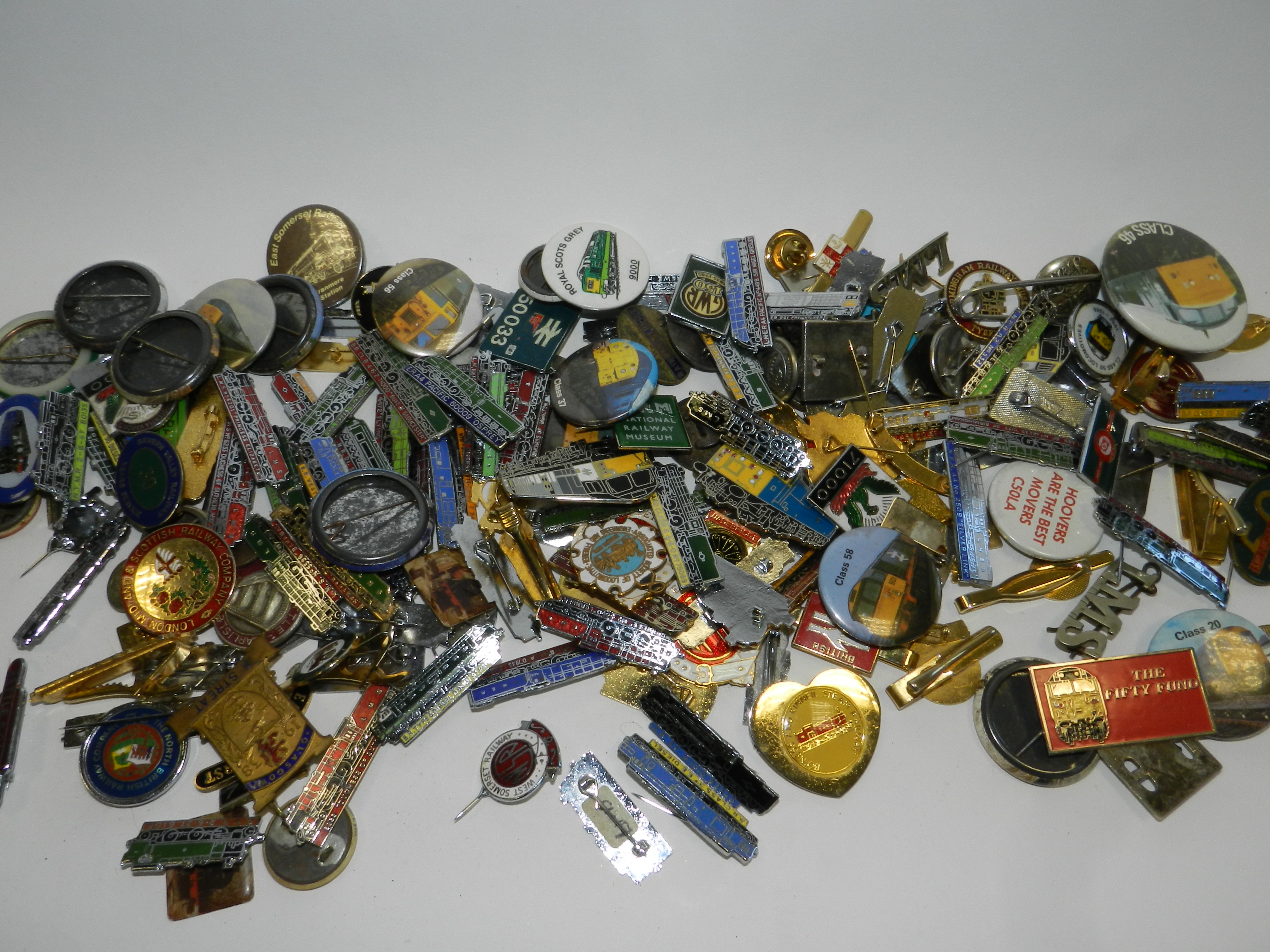 A large collection of various novelty badges