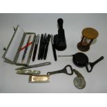 A group of pens, including Parker examples, a pen knife, a hole punch, an egg timer, a tape measure,
