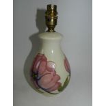A modern Moorcroft lamp base tubelined with Magnolia against a cream ground