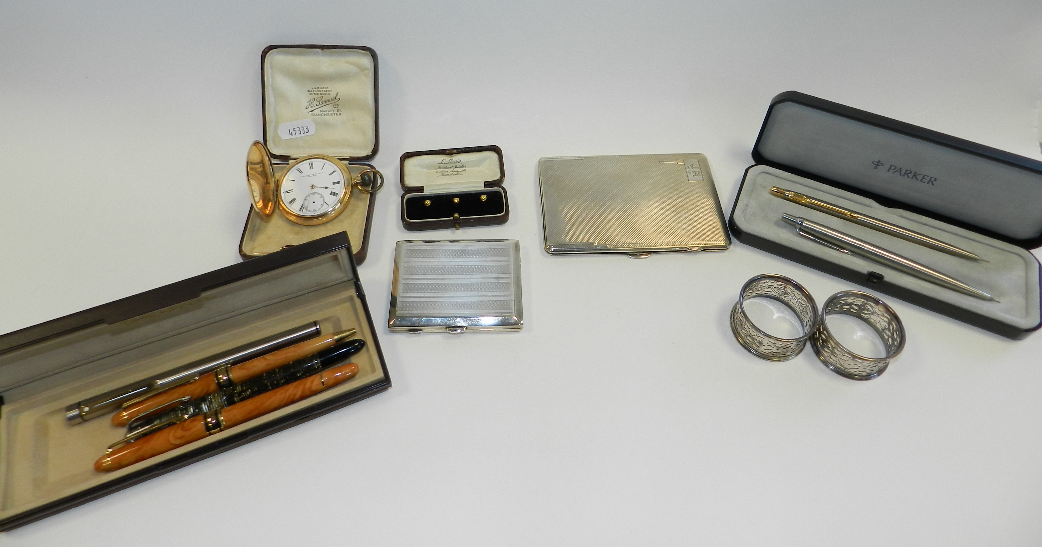 A silver cigarette case hallmarked Birmingham, together with a further silver cigarette case,