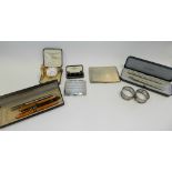 A silver cigarette case hallmarked Birmingham, together with a further silver cigarette case,