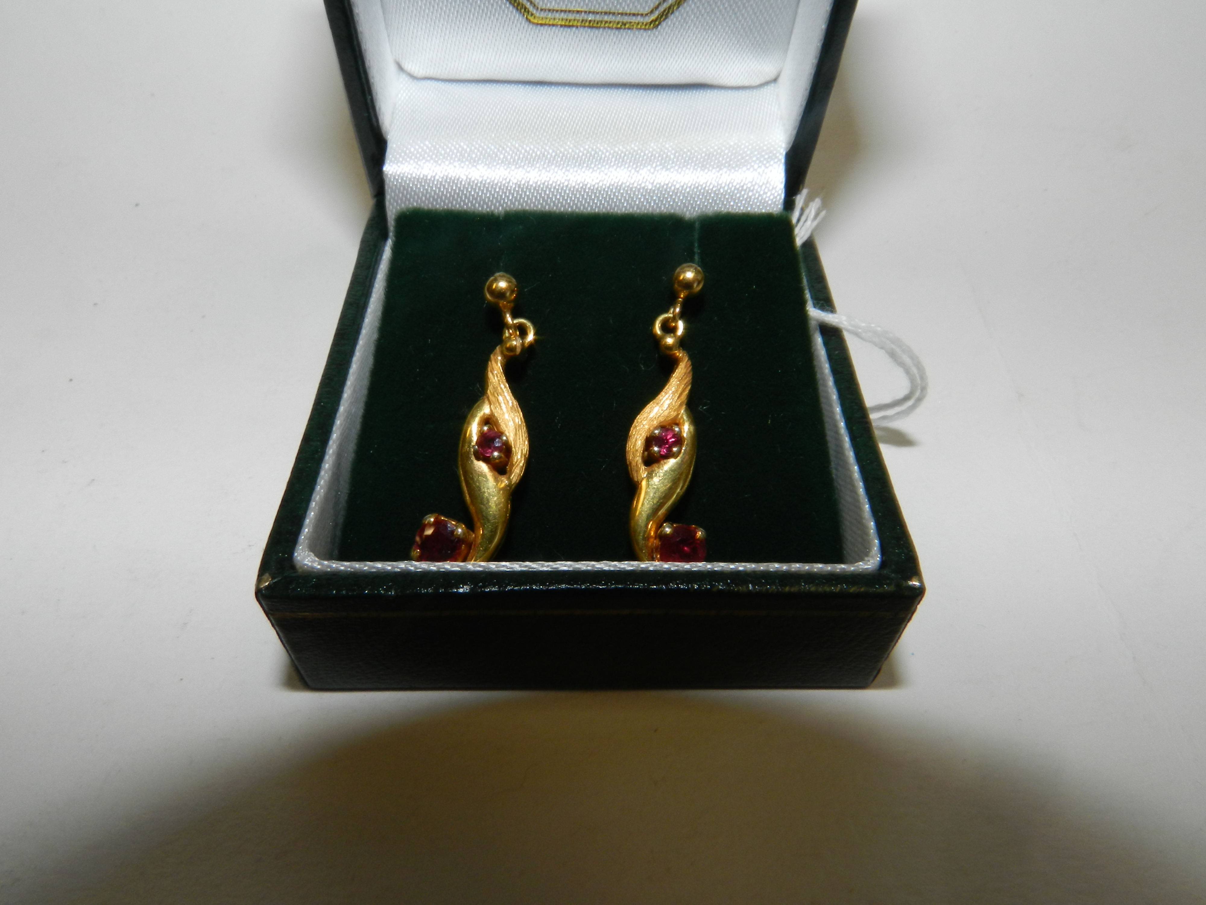 A pair of 9ct gold ruby set stylised ear pendants*