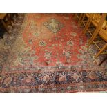 A large salmon ground Persian design carpet