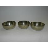 A set of three Eastern white metal bowls with engraved decoration*