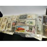 A large collection of various postcards to include embroidered examples and war examples