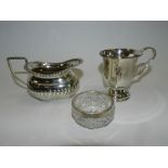 A half reeded silver cream jug, hallmarked Birmingham,