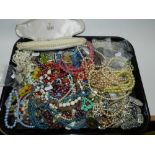 A large collection of pieces of costume jewellery to include a quantity of paste set brooches,