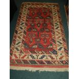 A modern cream and red ground geometrically designed rug