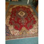 A modern red and cream ground Persian design carpet