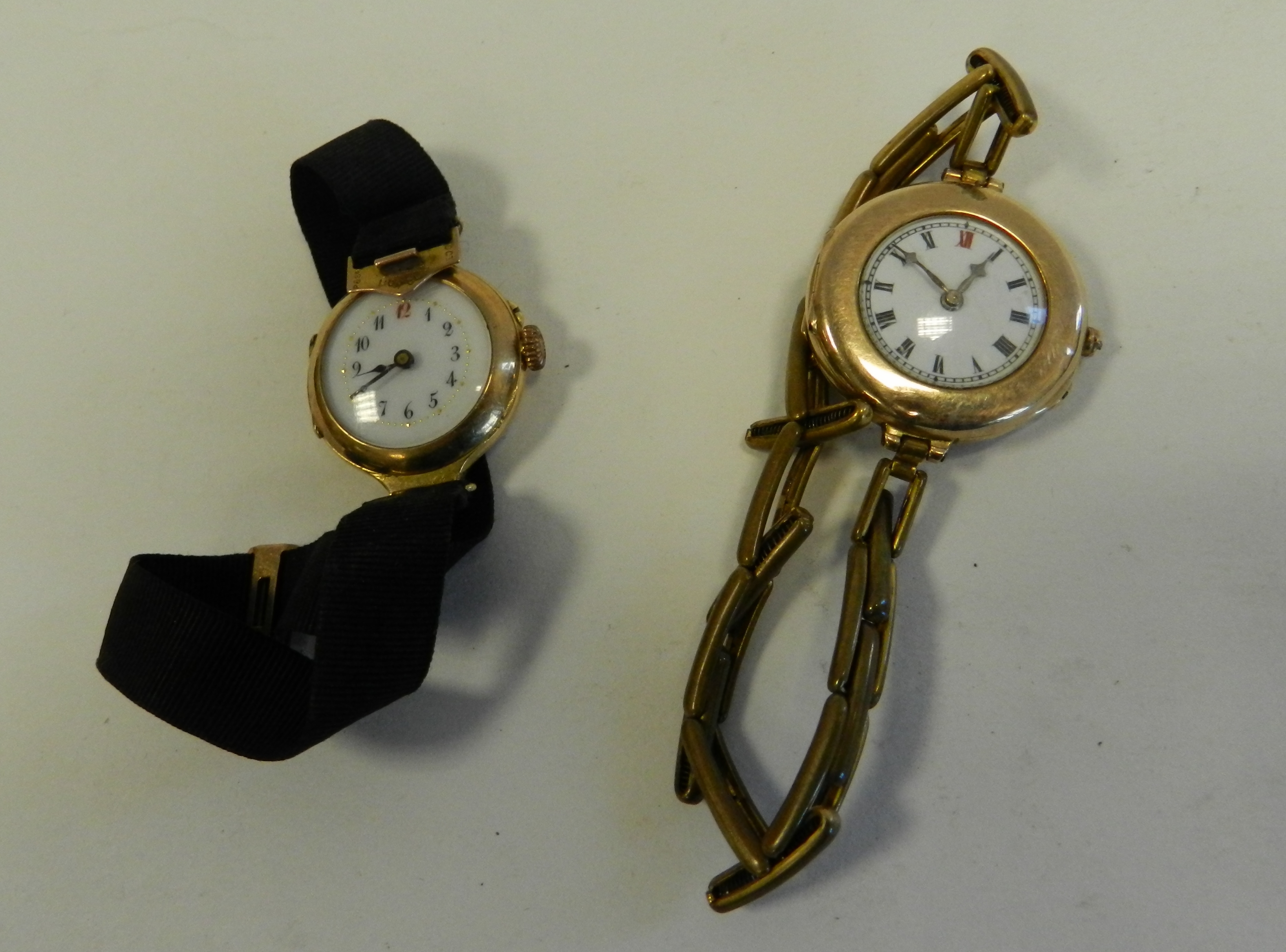 An 18 carat gold wristwatch with cord strap together with a 9 carat gold wristwatch with gilt metal