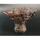 A Chinese carved buffalo horn libation cup, the sectional stem with slightly splayed foot,