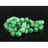 A jade bead necklace, comprising seventy-four uniform spherical jadeite beads,