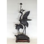 A very large Chinese bronze statue of two cranes and a turtle on a carved hardwood base, circa 1900,