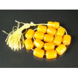 An amber bead rosary, the amber possibly reconstituted,