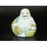 A Chinese porcelain figure of Budai, 20th century, enamelled in the famille rose palette,