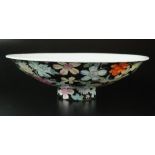 A Chinese famille noir pedestal dish, Qing Dynasty, 19th century, of circular form on a raised foot,