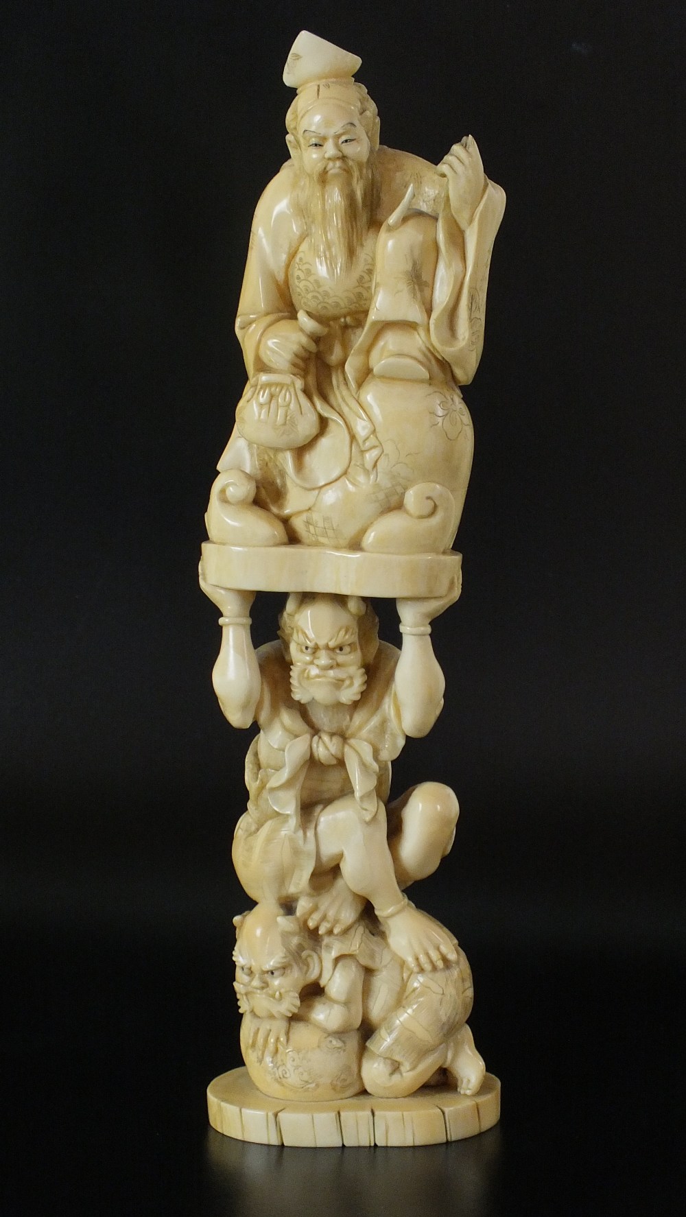 A Japanese carved marine ivory okimono, Meiji Period, late 19th century, carved as two Oni,