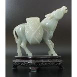 A Chinese carved mutton fat jade donkey, 20th century, of even celadon tone,