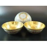 A group of three Cairoware copper and white metal inlaid brass bowls, 20th century,