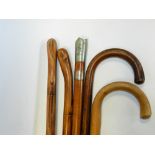 A small bundle of assorted walking canes to include a Signal Regiment swagger stick with white