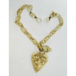 An ivory heart shaped pendant with carved floral decorations suspended on ivory link chain