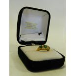 An 18 carat yellow gold seven stone emerald and diamond cluster ring designed as three graduated