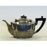 A half reeded oval silver teapot,