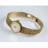 A Lady's 9ct gold Omega bracelet wristwatch, the circular silvered dial with batons, manual wind,