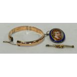 A 9 carat gold hinged bangle together with a yellow metal bar brooch and a ceramic plaque brooch