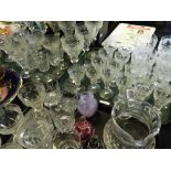 A collection of glassware to include a part suite decorated with engraved fruiting vines,