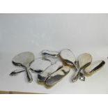 A collection of silver backed dressing table wares, comprising two hand mirrors,