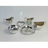 A silver two handled sugar bowl, together with matching cream jug,