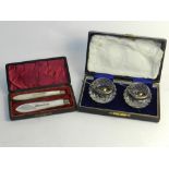 Two silver mounted glass salts with salt spoons together with a cased set of two mother of pearl