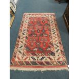 A modern cream and red ground Northwest Persian design rug.