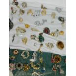 A collection of various modern costume brooches, including gold plated examples,