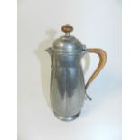 A Liberty & Co pewter coffee pot of elongated pumpkin form and hammered finish,