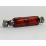 A Victorian ruby glass double ended white metal mounted scent bottle of cylindrical faceted form,