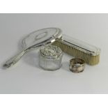 A silver backed hand mirror, together with a silver backed clothes brush,