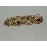 A garnet and blister pearl openwork panel bracelet,