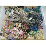 A large collection of various pieces of costume jewellery to include bangles, bead necklaces,