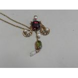 An early 20th century garnet seed pearl and peridot set necklace,