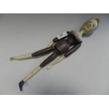 A wooden composition jointed doll with painted face,