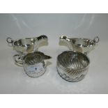 A pair of Dublin silver sauce boats together with a Victorian shell moulded silver cream jug and