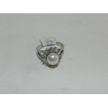 A freshwater cultured pearl and white stone cluster ring