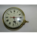 A brass ships bulk head timepiece with Roman numerals *