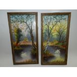 A pair of framed tile panels painted with swans in riverscapes