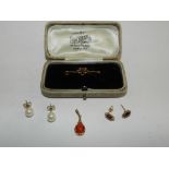 A 9ct gold ruby set bar brooch together with a pair of 9ct gold ruby set earrings,