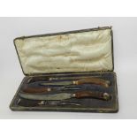 A cased set of silver mounted horn carvers, TEO, Sheffield 1925, comprising two knives,